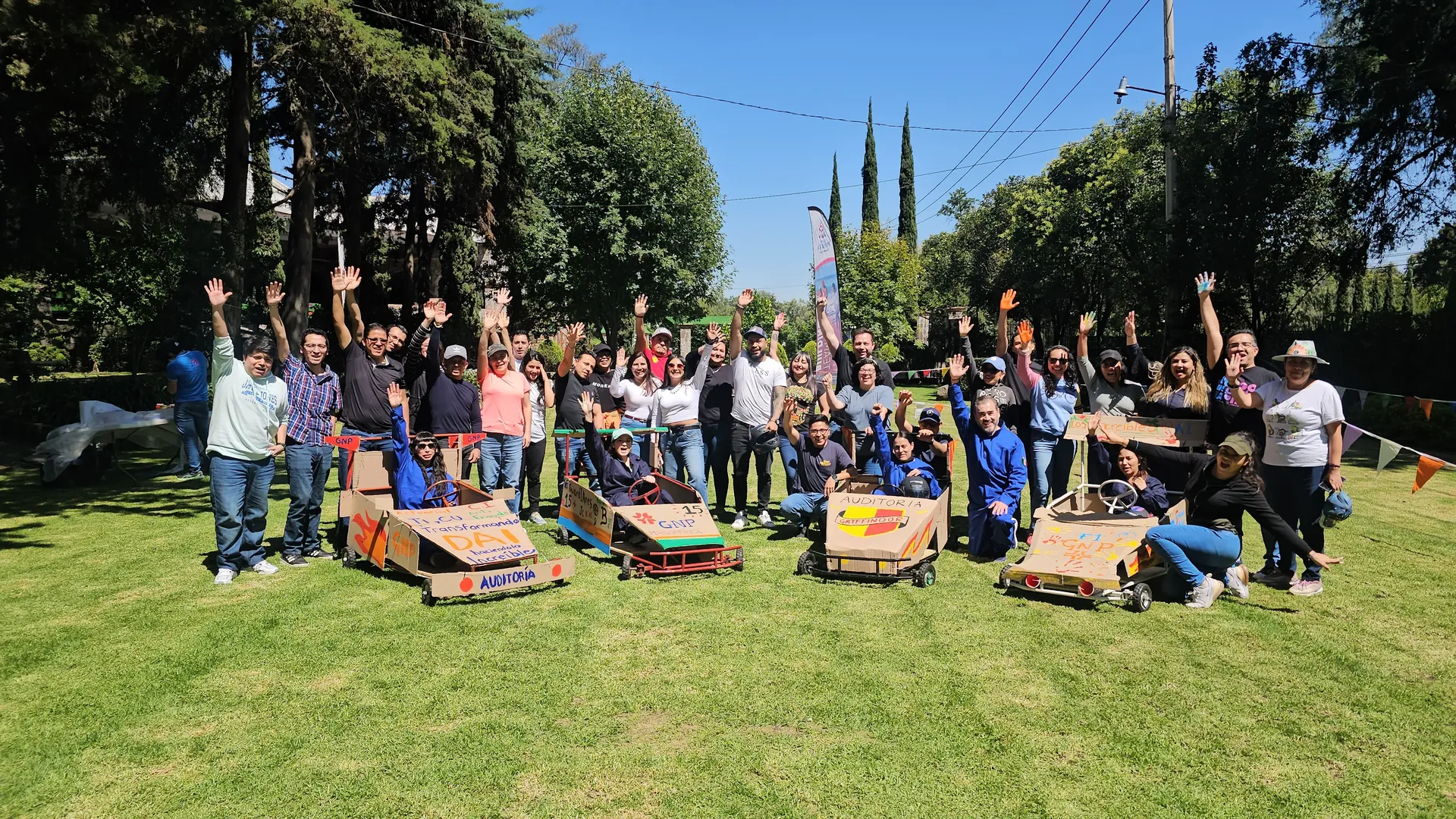 Colaboradores de GNP celebrando el éxito de su proyecto en una dinámica de team building colaborativo.