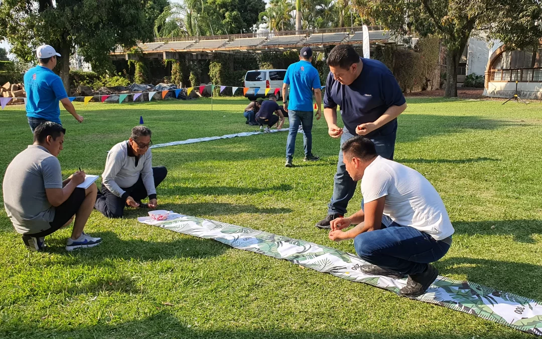 Fotografía de colaboradores de una empresa realizando actividades de talleres de comunicación al aire libre.
