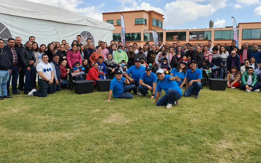 Proceso de integración laboral: fotografía de un grupo grande de colaboradores en el pasto al aire libre.